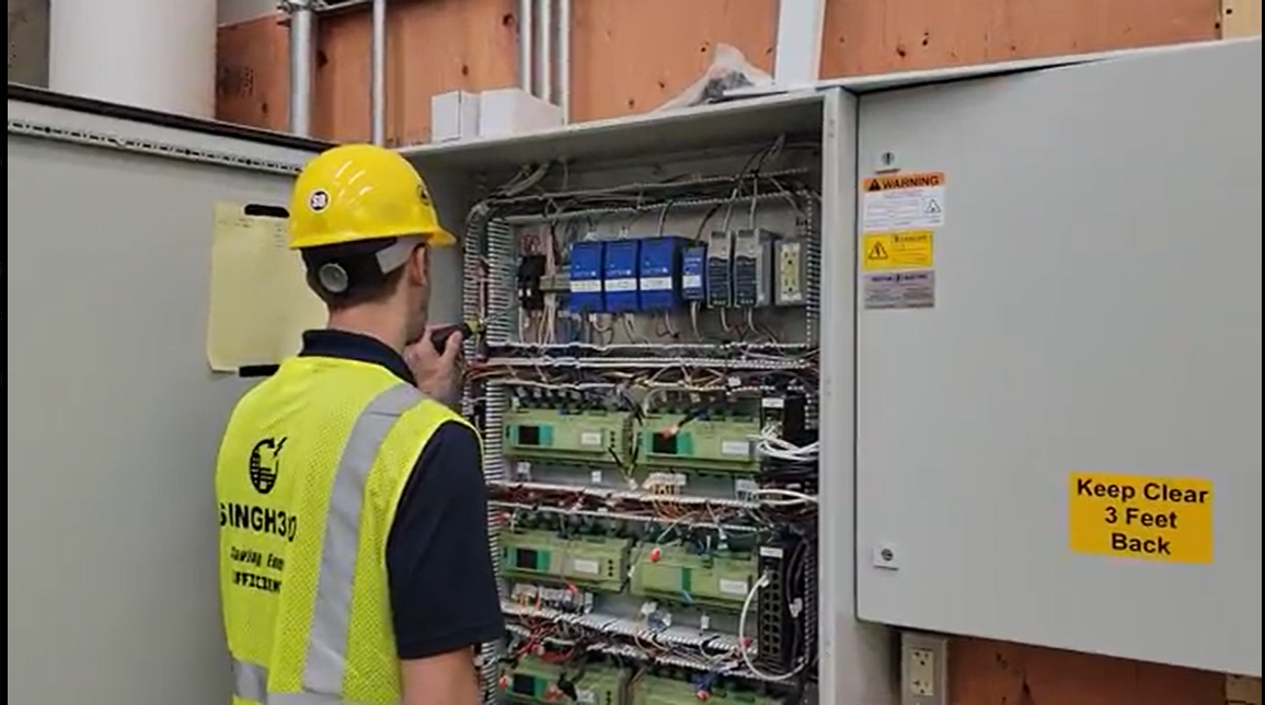 Singh360 technician verifying controls work at an open panel