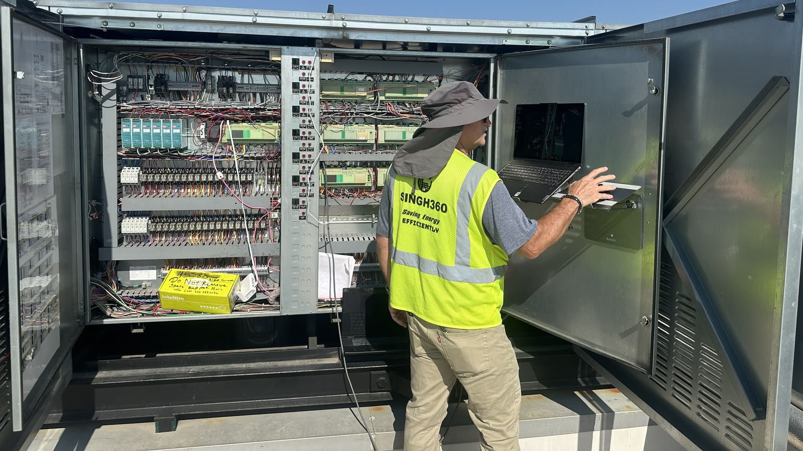 Singh360 technician working at a full-store controls installation